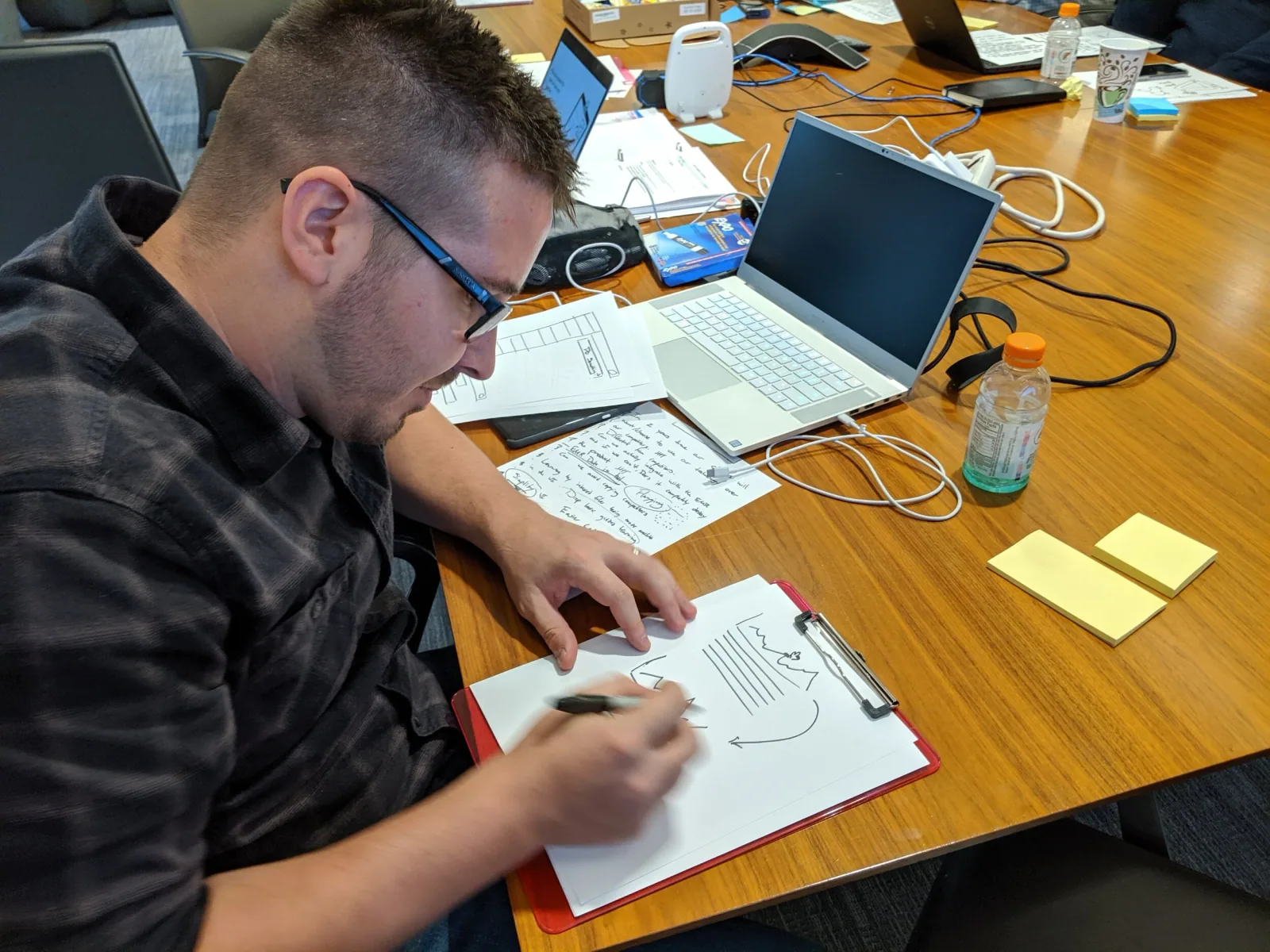 Dan sketching at the table during the design sprint